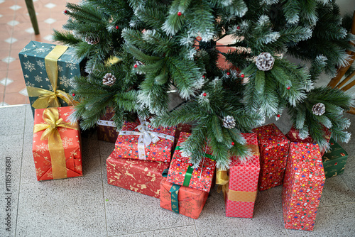 Obraz na płótnie Merry x-mas,Close up of multiple gift boxes,Colorful balls and Christmas greeting picture parcel,Santa doll decoration on Green Christmas tree background Decoration During Christmas and New Year. w salonie