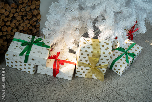 Merry x-mas,Close up of multiple gift boxes,Colorful balls and Christmas greeting picture parcel,Santa doll decoration on Green Christmas tree background Decoration During Christmas and New Year.