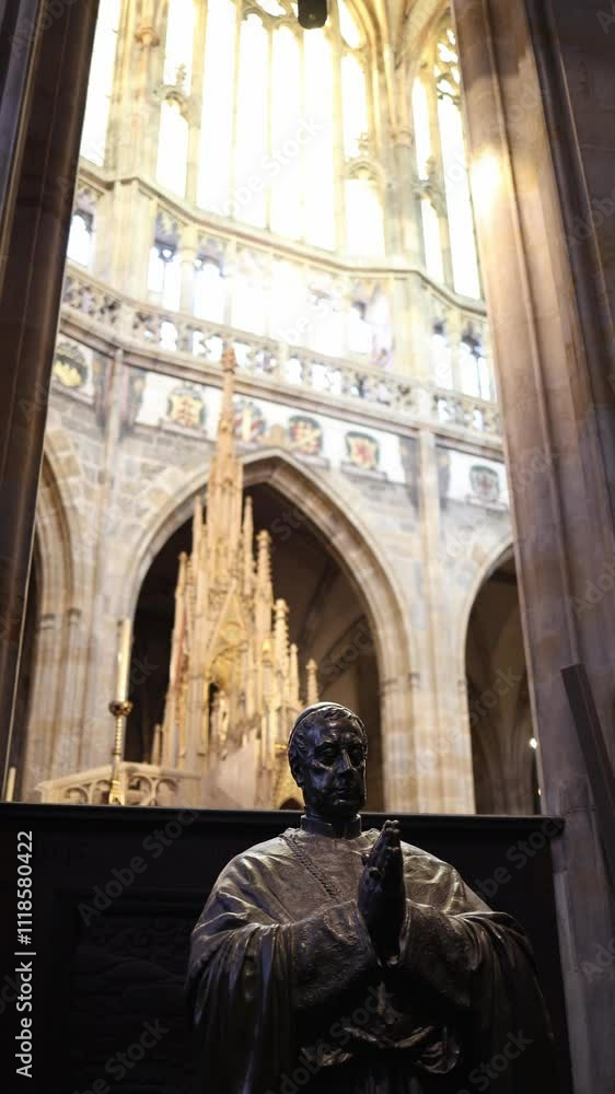 A solemn bronze statue of a praying clergyman, rich in detail, positioned against a backdrop of Gothic architecture and glowing stained glass. The ornate spire in the background adds depth to the spir A solemn bronze statue of a praying clergyman, rich in detail, positioned against a backdrop of Gothic architecture and glowing stained glass. The ornate spire in the background adds depth to the spir