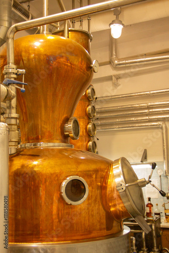 Distillate production process in copper distillation unit. Cpper vacuum still for distillation performed under reduced pressure for gin production.