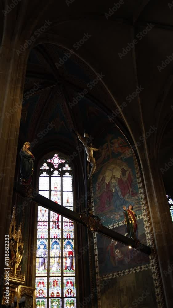 A remarkable crucifixion scene suspended in the cathedral, featuring a lifelike figure of Christ flanked by statues of the Virgin Mary and Saint John. Behind, vivid stained glass and detailed frescoes A remarkable crucifixion scene suspended in the cathedral, featuring a lifelike figure of Christ flanked by statues of the Virgin Mary and Saint John. Behind, vivid stained glass and detailed frescoes