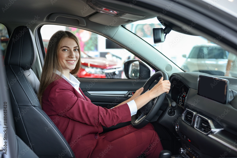 Young woman inside new car in salon Young woman inside new car in salon