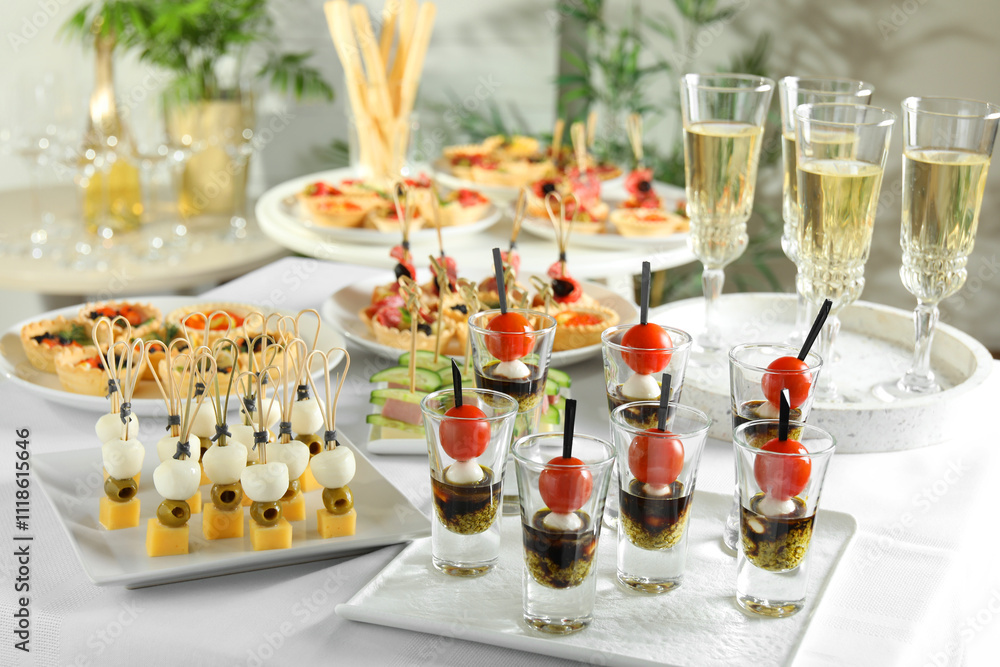 Many different tasty canapes and wine on white table Many different tasty canapes and wine on white table