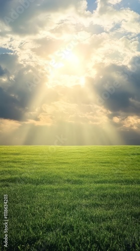 Sun Rays Through Clouds over Green Field 