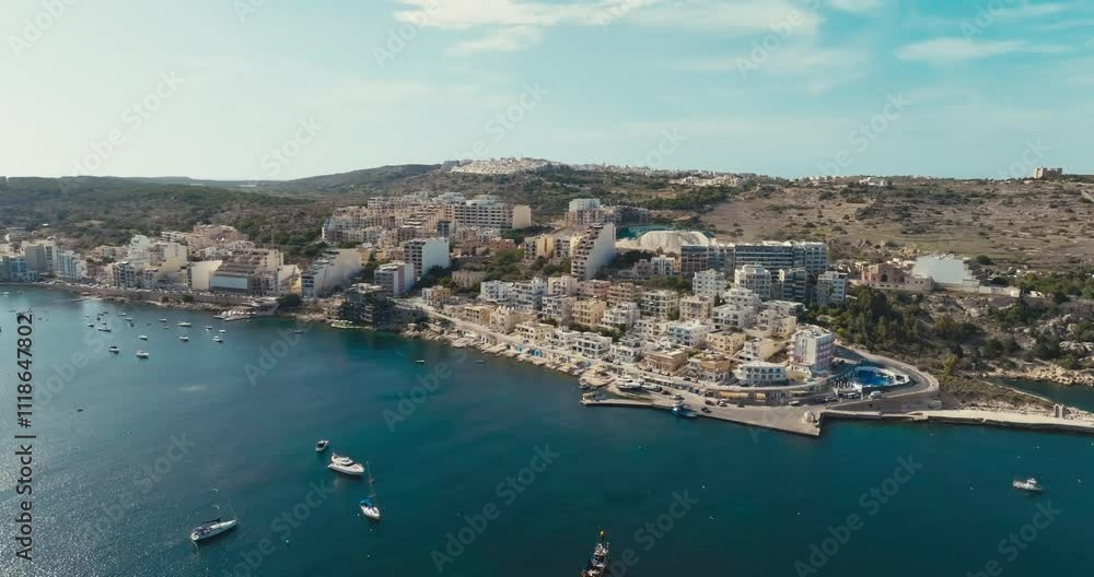 Aerial Drone View of Bugibba Malta Showcasing Coastal Cityscape with Tourist Beaches Marina Yachts and Mediterranean Waters. High quality 4k footage Aerial Drone View of Bugibba Malta Showcasing Coastal Cityscape with Tourist Beaches Marina Yachts and Mediterranean Waters. High quality 4k footage