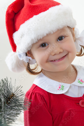 Portrait of little cute girl in  Santa Claus costume in Christmas