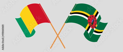 Crossed and waving flags of Guinea and Dominica. Vector illustration