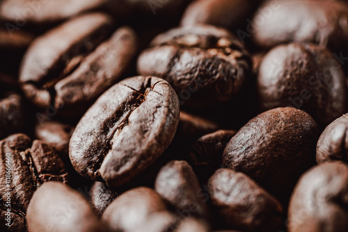 Close-up of roasted coffee beans showcasing their rich texture and deep brown color. Ideal for coffee-related themes, beverages, or culinary content. photo