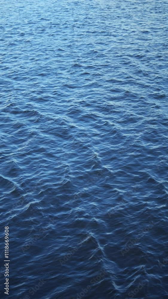 A Tranquil and Serene Calm Blue Water Surface Overlapping with Gentle, Soft Ripples A Tranquil and Serene Calm Blue Water Surface Overlapping with Gentle, Soft Ripples