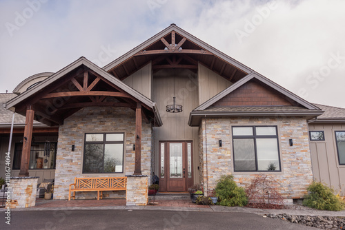 Front of modern house with stone veneer siding and arched roof