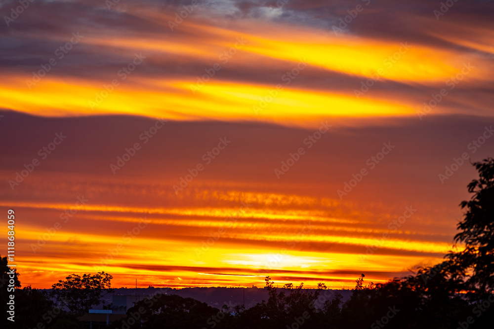 Sunrise with intense natural orange lights and idyllic dramatic scenery Sunrise with intense natural orange lights and idyllic dramatic scenery