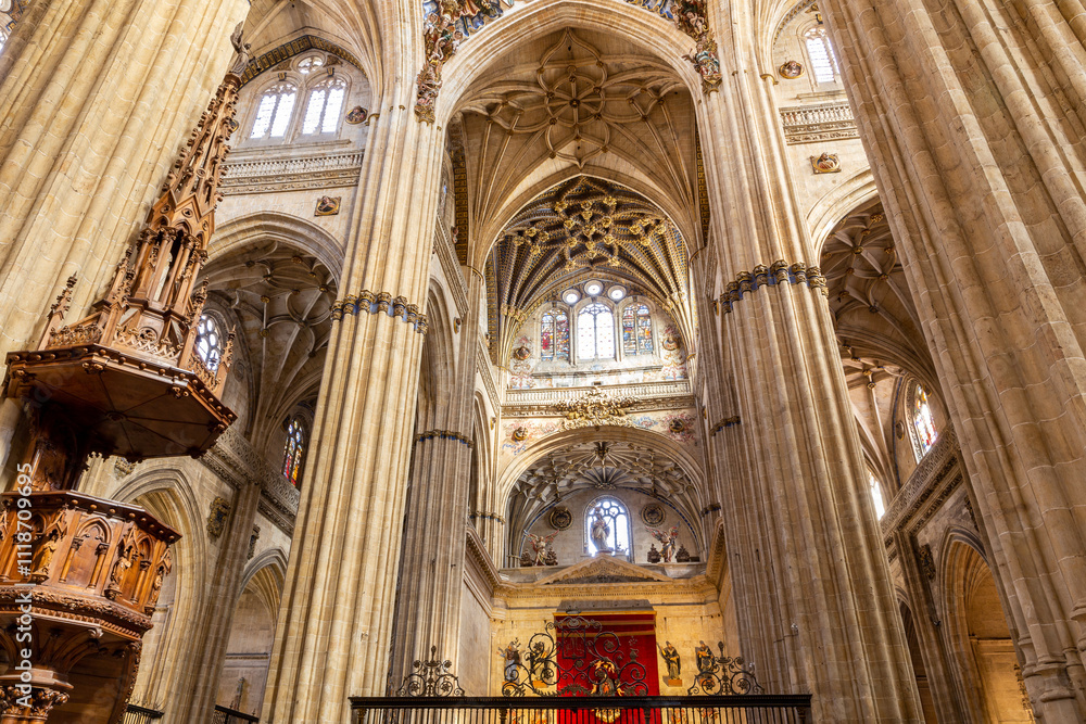 Naklejka premium Richly decotated New Cathedral (Catedral Nueva) in Salamanca, Spain, inside view with decorative stone vaults, columns and stained glass windows.