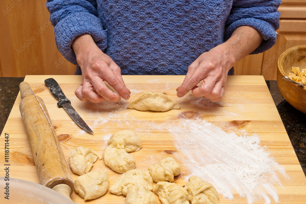 Cooking pirogies. Dough. Female hands making cookies over wooden table Cooking pirogies. Dough. Female hands making cookies over wooden table