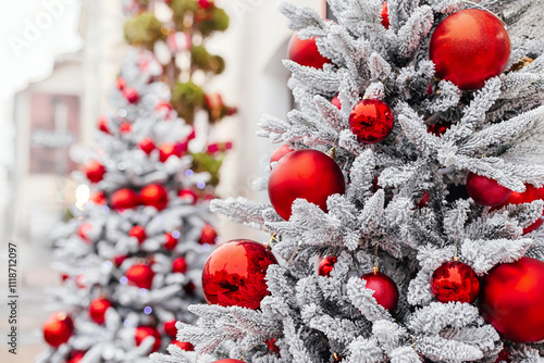 A Christmas scene with a shiny red ball, gift, and glittering garlands