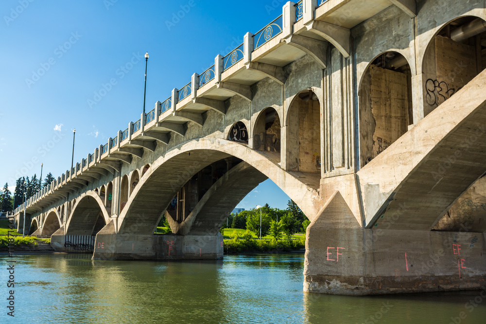 A bridge spans a river with a greenish tint A bridge spans a river with a greenish tint