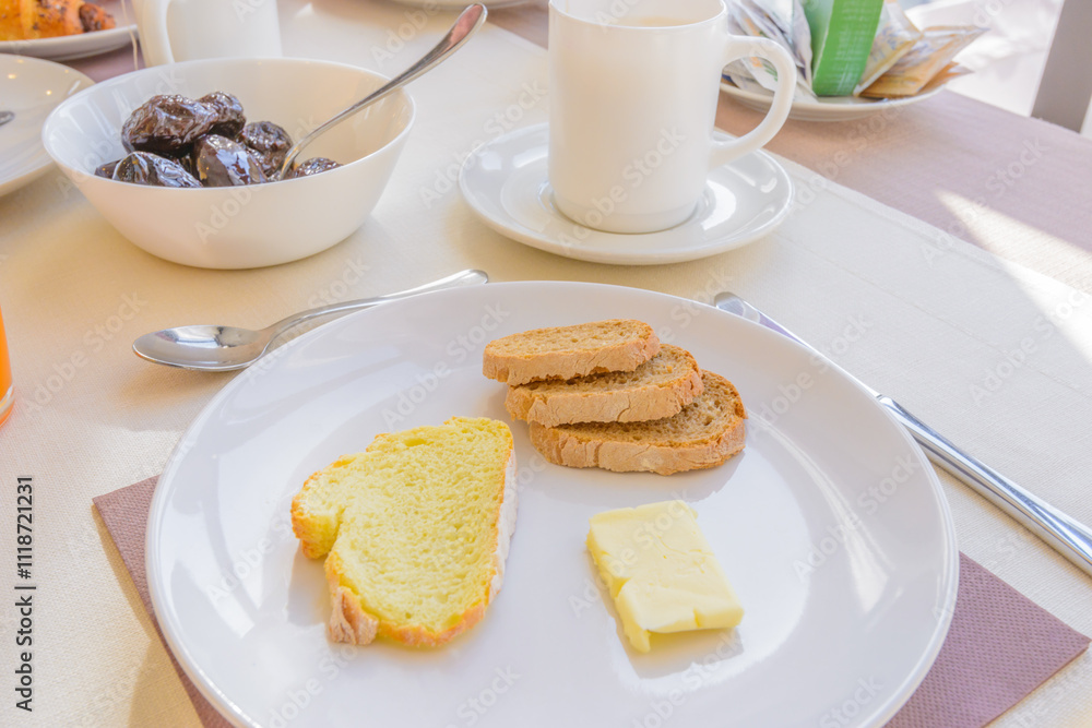 Breakfast including coffe, bread, and butter. Breakfast including coffe, bread, and butter.