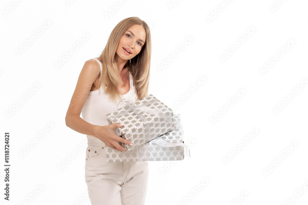A young woman smiles while holding gift-wrapped presents in a bright, minimalistic setting during the daytime A young woman smiles while holding gift-wrapped presents in a bright, minimalistic setting during the daytime