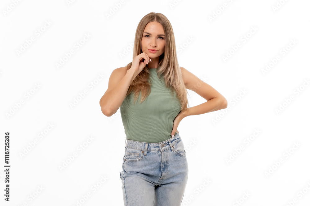 A young woman poses confidently in casual attire against a white background, showcasing her fashion sense and style A young woman poses confidently in casual attire against a white background, showcasing her fashion sense and style