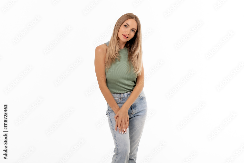 Young woman in casual attire poses gracefully against a plain backdrop during a photoshoot, exuding confidence and style Young woman in casual attire poses gracefully against a plain backdrop during a photoshoot, exuding confidence and style