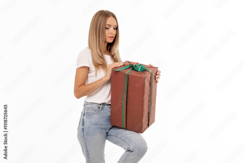 A young woman unwraps a beautifully wrapped gift indoors, showcasing excitement on a bright and cheerful day A young woman unwraps a beautifully wrapped gift indoors, showcasing excitement on a bright and cheerful day