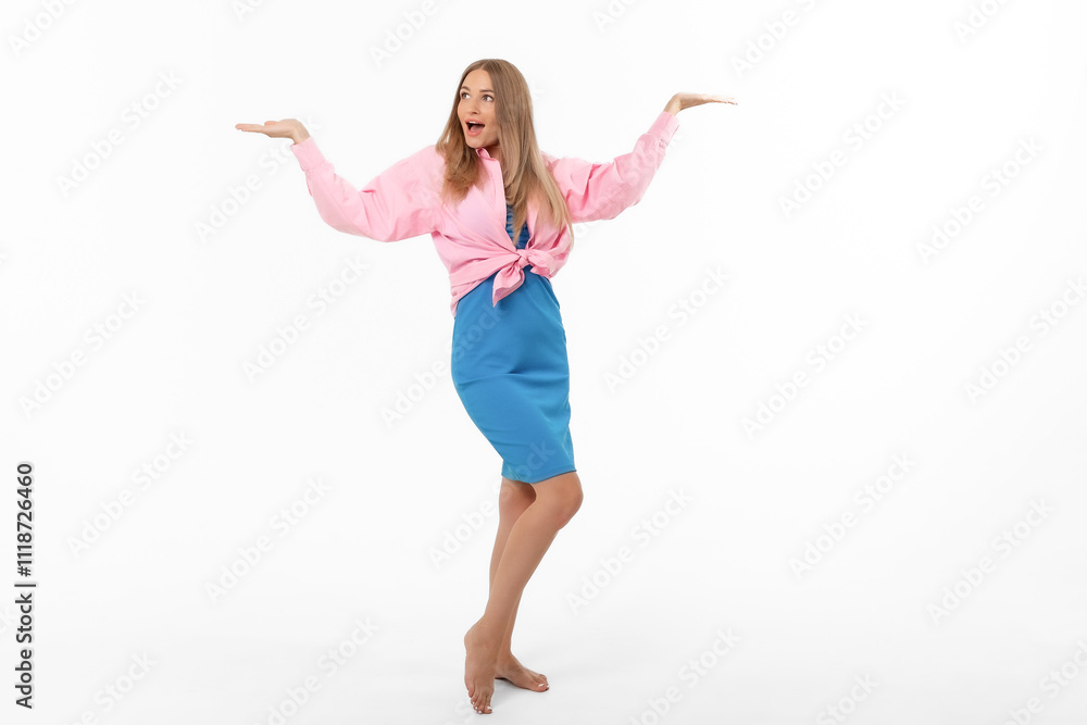 A joyful woman poses with outstretched arms in a colorful outfit against a plain white background A joyful woman poses with outstretched arms in a colorful outfit against a plain white background