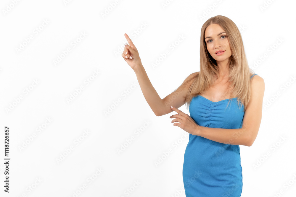 Young woman wearing a blue dress gestures towards an empty space, likely promoting a product or idea in a studio setting Young woman wearing a blue dress gestures towards an empty space, likely promoting a product or idea in a studio setting