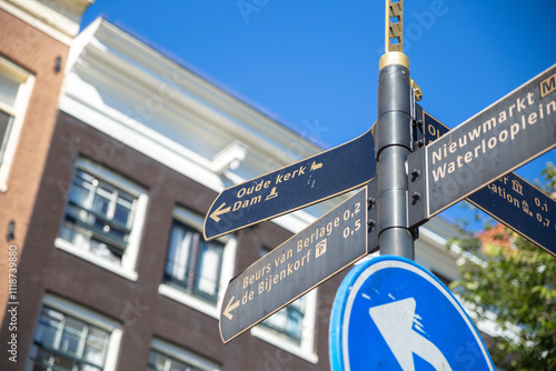 the road sign to old church and dam in Amsterdam, tourism in Netherlands