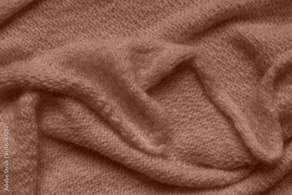 Texture of brown knitted woolen fabric with folds Texture of brown knitted woolen fabric with folds