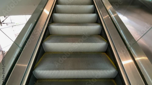 First Person POV empty moving up escalator on public place, Low angle shot of escalator. escalator steps moving up, close up view of steps.