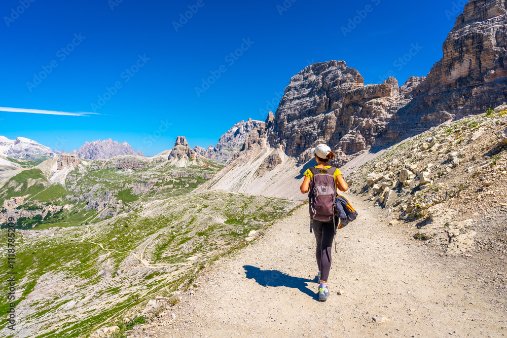 Naklejka premium Tourist walking on the tre cime di lavaredo trail in the dolomites, italy