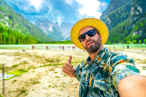 Tourist enjoying summer holidays at lago di landro giving thumbs up photo