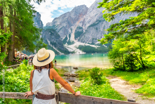 Canvas-taulu Tourist admiring stunning lake braies in the italian dolomites during summer