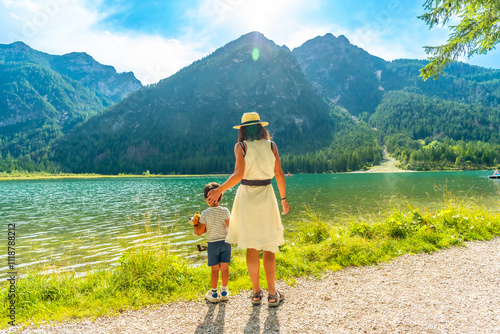 Photos Mother and son admiring lake dobbiaco in the dolomites