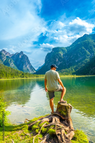 Tourist enjoying stunning view of lake dobbiaco in the dolomites photo