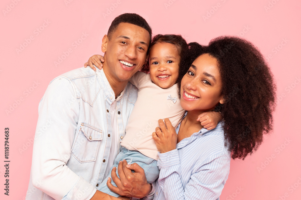 Loving black parents and little daughter sharing warm embrace, father, mother and female kid smiling at camera, standing over pink background Loving black parents and little daughter sharing warm embrace, father, mother and female kid smiling at camera, standing over pink background