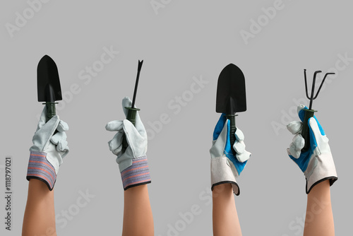 Female hands with gardening tools on grey background photo