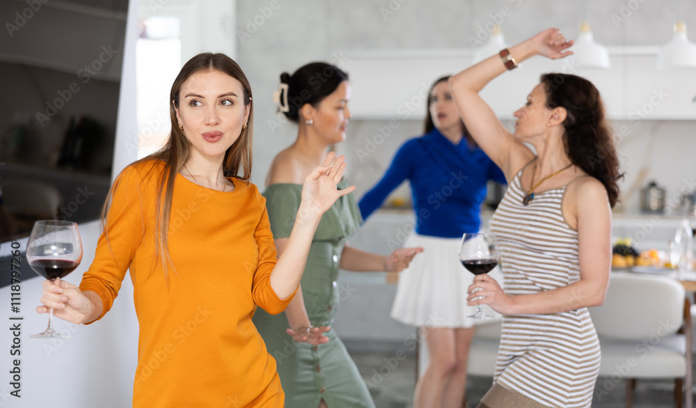 Naklejka premium Happy women dancing at a bachelorette party - girlfriends home party