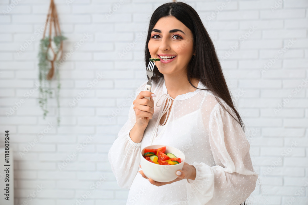 Young pregnant woman eating vegetable salad at home Young pregnant woman eating vegetable salad at home