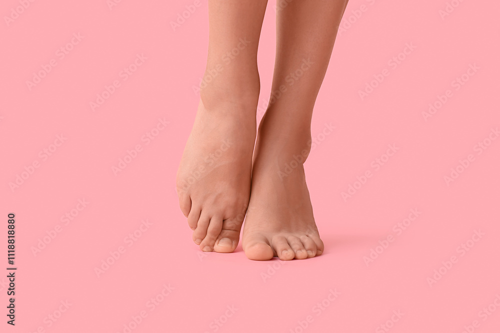Barefoot legs of young woman on pink background Barefoot legs of young woman on pink background
