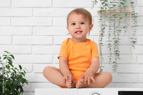 Cute little baby sitting on...