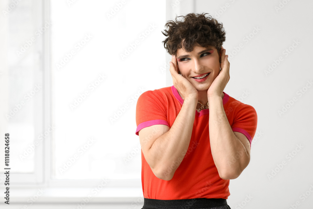 Young transgender woman near window at home Young transgender woman near window at home