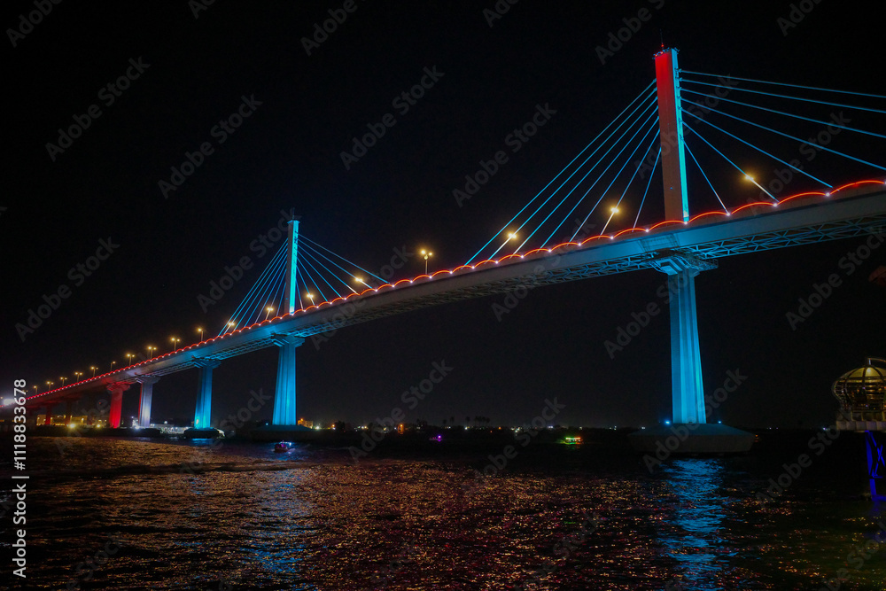 Fototapeta premium Illuminated Bridge and Boats at Night