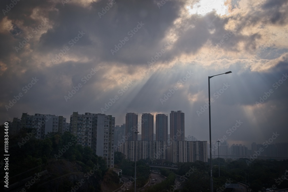 Fototapeta premium Dramatic Urban Landscape with Sunlight and Clouds