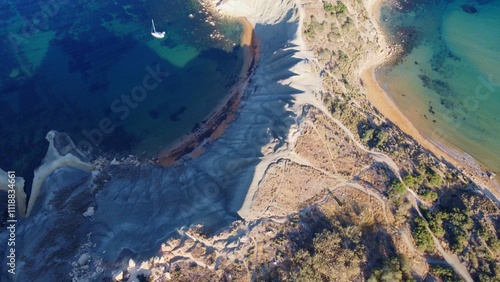 Clay cliffs flat rock cape Qarraba Bay, golden sand and emerald water in the early morning still in the shade. Aerial top down view. High quality photo photo