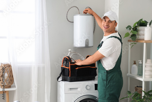 Male plumber fixing boiler ...