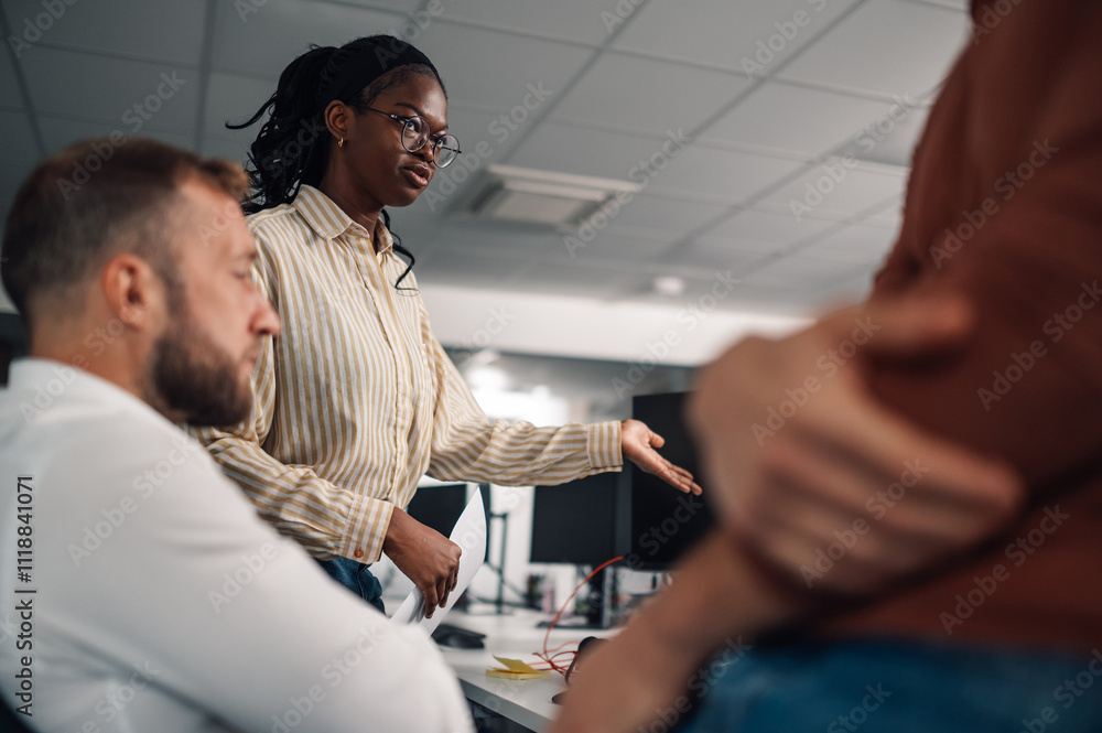 Fototapeta premium Project manager leading a team meeting, explaining strategy on computer screen
