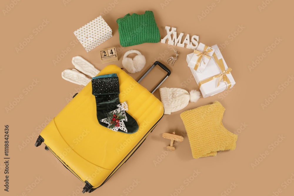 © Pixel-Shot - Suitcase with winter accessories and Christmas gifts on beige background. Travel concept. Top view © Pixel-Shot - Suitcase with winter accessories and Christmas gifts on beige background. Travel concept. Top view