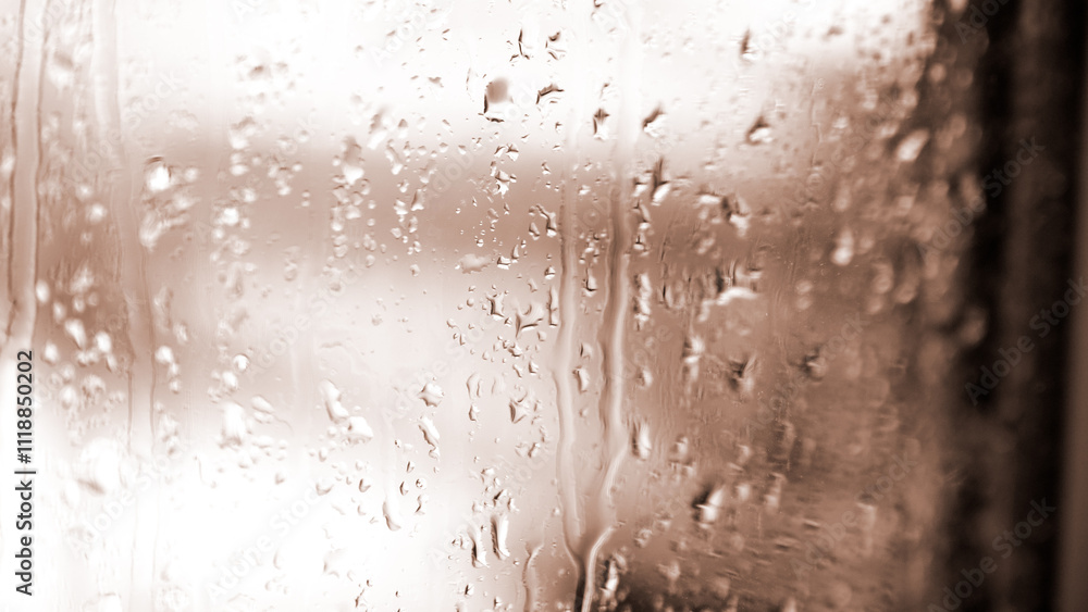 Macro of water drops on glass. Large rain drops strike window during winter shower. Colour of the year Mocha Mousse Macro of water drops on glass. Large rain drops strike window during winter shower. Colour of the year Mocha Mousse