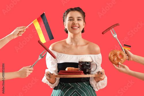 Young Octoberfest waitress with beer and traditional German food on red background photo