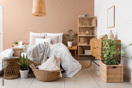 Interior of modern bedroom with big bed, shelving unit and houseplants